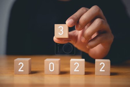 Photo for Happy New Year 2023. Happy businessman hand holding number 3 on wooden block to put replace or change previous year 2022, Business risk management, solution, Resolution, strategy, goal - Royalty Free Image
