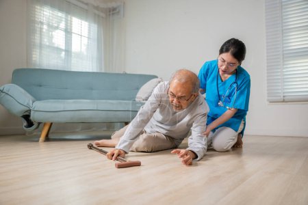 Photo for Disabled elderly old man patient with walking stick fall on floor and caring young assistant at nursing home, Asian older senior man falling down on lying floor and woman nurse came to help support - Royalty Free Image