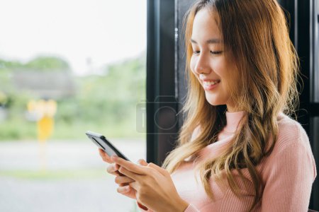 Photo for Asian young woman hands holding mobile phone at cafe coffee shop, Happy beautiful female typing text message on smart phone device and enjoyment lifestyle with social networking media - Royalty Free Image