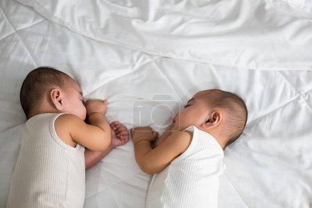 Photo for Asian two adorable twin babies boy, Happy childhood, Sleeping newborn identical boy twins on the bed on bedroom, family people infant - Royalty Free Image