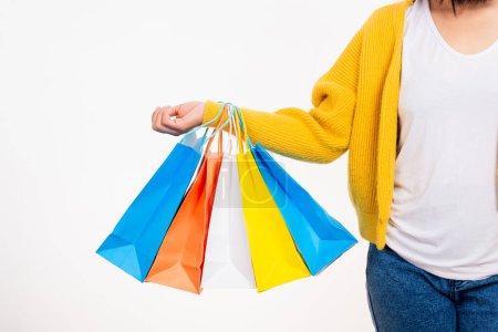 Photo for Happy woman hand she wears yellow shirt holding shopping bags multicolor, young female hold many packets within arms isolated on white background, Black Friday sale concept - Royalty Free Image