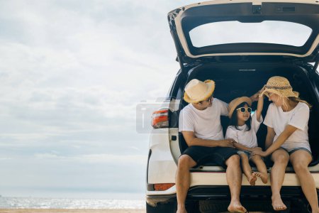 Photo for Parents and children travel in holiday at sea beach, family having fun in summer vacation on beach blue sky, People enjoying road trip sitting down on back their car, Happy Family and Road trips Day - Royalty Free Image
