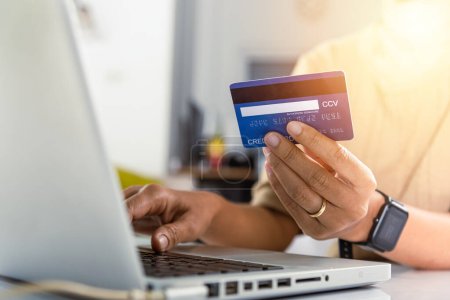 Photo for Online shopping. Woman hands holding credit card and using laptop with product purchase at home, female register via credit cards on computer to make electronic payment security online - Royalty Free Image