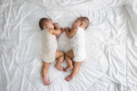 Photo for Happy childhood, Sleeping newborn identical boy twins on the bed on bedroom, Asian two adorable twin babies boy, family people infant - Royalty Free Image