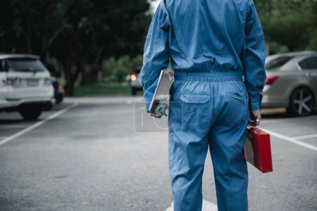 Photo for Back mechanic man maintenance with tools togo service repair outdoor, Closeup of professional technician come to checking condition of car, The auto mechanic works car broken outside - Royalty Free Image