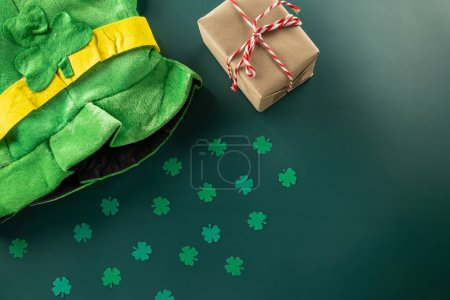 Photo for Happy St Patricks Day decoration background concept. shamrocks leaves holiday symbol with copy space on green background, above view gift box green clover leaves - Royalty Free Image