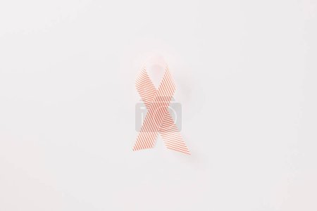 Téléchargez les photos : Close up pink awareness ribbon of International World Cancer Day campaign isolated on white background with copy space, concept of medical and health care support, 4 February - en image libre de droit