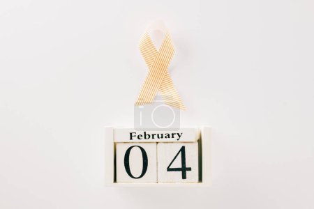 Photo for Pink awareness ribbon sign and Calender 4 February of World Cancer Day campaign isolated on white background with copy space, concept of medical and health care support - Royalty Free Image
