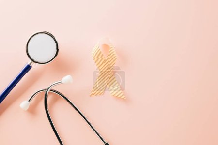 Foto de Pink awareness ribbon sign and stethoscope of International World Cancer Day campaign month on pastel pink background with copy space, concept of medical and health care support, 4 February - Imagen libre de derechos