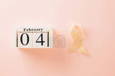 Foto de Pink awareness ribbon sign and Calender 4 February of World Cancer Day campaign on pastel pink background with copy space, concept of medical and health care support - Imagen libre de derechos