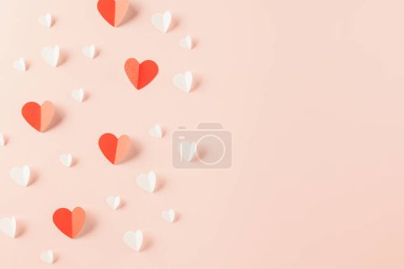 Photo for Happy Valentines Day background. Top view flat lay of paper elements cutting white and red hearts shape flying on pink background with copy space, Happy Mothers Day, Banner template design of holiday - Royalty Free Image