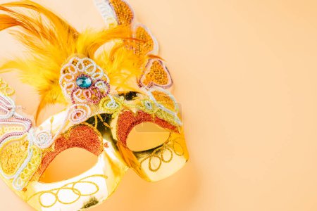 Photo for Happy Purim carnival decoration. Golden venetian ball mask isolated on pastel background, Jewish Purim and Mardi Gras in Hebrew, holiday background banner design with copy space, Masquerade party - Royalty Free Image