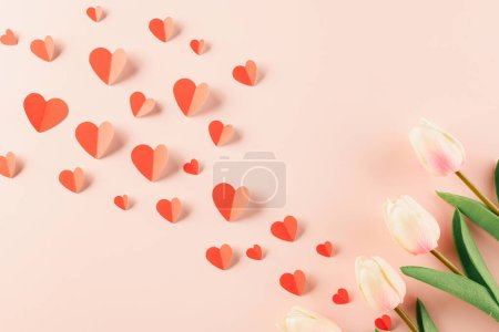 Photo for Happy Valentines Day background. Top view flat lay of red paper hearts shape and pink tulips flower on pink background with copy space, Valentine day concept, Banner of holiday - Royalty Free Image
