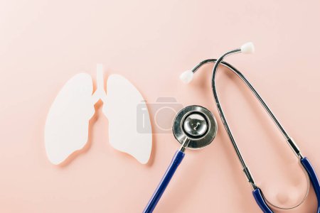 Photo for World TB Day. Top view of lungs paper symbol and medical stethoscope on pink background, copy space, lung cancer awareness, concept of world tuberculosis day, banner background, pneumonia - Royalty Free Image