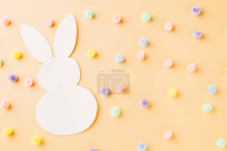 Photo for Easter Day Concept. Above overhead handmade white paper rabbit cutting isolated on pastel background with copy space for your text, Happy Easter Bunny holiday, Banner design for web - Royalty Free Image