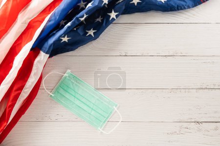 Téléchargez les photos : Happy presidents day. flag of United States America with copy space, Top view USA flag and face protection for coronavirus on white wood background board, banner design, Patriot Day, COVID-19 - en image libre de droit