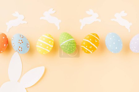 Photo for Easter eggs bunny and rabbit white paper cutting isolated on pastel background. Funny decoration, Happy Easter Day, Festive composition banner design holiday background - Royalty Free Image
