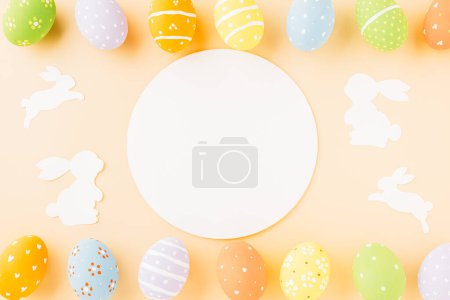 Photo for Overhead easter eggs with rabbit paper cut and circle white paper isolated on pastel background, Funny decoration paper round blank, Happy Easter Day, Creative banner web design holiday background - Royalty Free Image