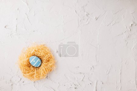 Foto de Top view holiday banner background web design white easter eggs in brown nest on white cement background with empty copy space, celebration greeting card, overhead, template, Happy Easter Day Concept - Imagen libre de derechos