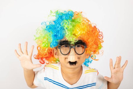 Photo for April Fools Day. Two brothers funny kid boy clown wears curly wig colorful big nos and glasses and has mustache playing fool isolated on white background with copy space, Happy child festive decor - Royalty Free Image