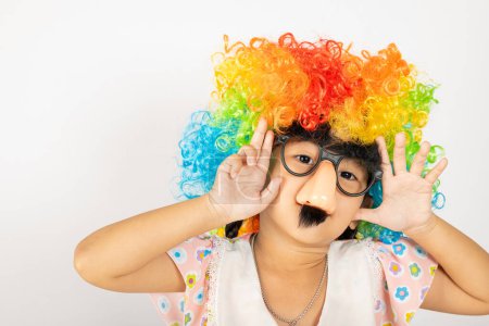 Photo for April Fools Day. Two brothers funny kid little girl clown wears curly wig colorful big nos and glasses and mustache playing fool isolated on white background copy space, Happy child festive decor - Royalty Free Image