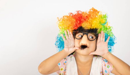 Photo for April Fools Day. Two brothers funny kid little girl clown wears curly wig colorful big nos and glasses and mustache playing fool isolated on white background copy space, Happy child festive decor - Royalty Free Image