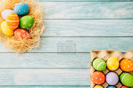 Foto de Top view holiday banner background web design white easter eggs in brown nest on blue wooden background with empty copy space, celebration greeting card, overhead, template, Happy Easter Day Concept - Imagen libre de derechos