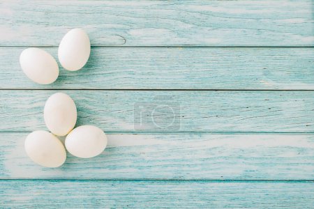 Photo for Happy Easter Day Concept. Overhead of holiday banner background design white easter eggs on blue wooden background with empty copy space, celebration greeting card - Royalty Free Image