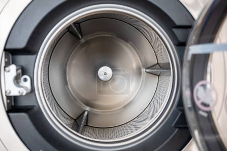 Photo for Close up brand new drum material metal electrical household appliance, Inside of washing machine tub is made of stainless steel, Empty inside - Royalty Free Image