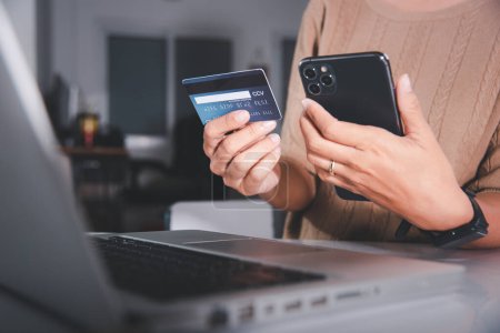 Photo for Female register via credit cards on mobile phone make digital payment security online, Business woman hands holding credit card and smartphone to pay product at home, Internet online shopping concept - Royalty Free Image