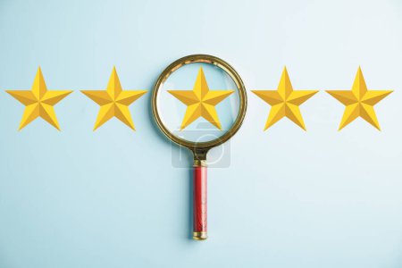 Photo for Customer using magnifier glass, focusing on five stars icon for rating service. Satisfaction evaluation survey and review. Excellent rating. User delivers feedback for good business network score. - Royalty Free Image