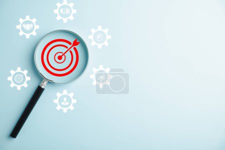 Photo for Magnifier to analyze a target icon, offering objective insights and guiding management. It represents the concept of gear planning, development, and propelling business forward. - Royalty Free Image