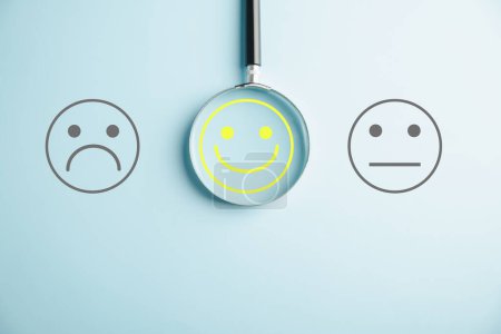 Photo for Magnifier glass uncovers smiley face, finding happiness amid sadness. Customer satisfaction and evaluation following service or marketing survey. Magnifying, satisfaction, reputation highlighted. - Royalty Free Image