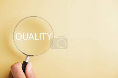 Photo for Magnifying glass against enhances the word Quality emphasizing the concept of control and compliance. It represents the rules, policies, and regulations that ensure the companys Terms and Conditions. - Royalty Free Image