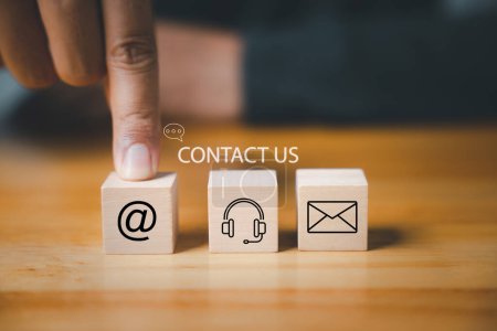 Photo for Website page contact us or e-mail marketing concept. Customer support hotline connects people. Wood cube with email, phone, address, and headset icons. Corporate communication solution is. - Royalty Free Image