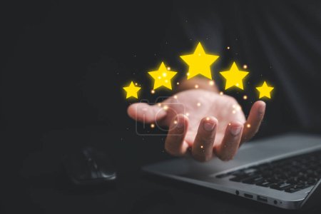 Photo for Give your business a boost with positive customer reviews Showcase your service rating with a hand holding five gold stars. Customer service and Satisfaction concept, 5 star rating - Royalty Free Image