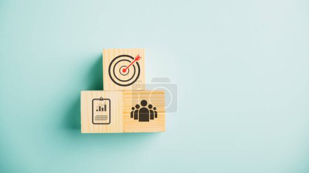 Photo for Wooden cube block step on a table with Action Plan, Goal, and Target icons. Success and business target concept. Project management and company strategy on a blue background. - Royalty Free Image