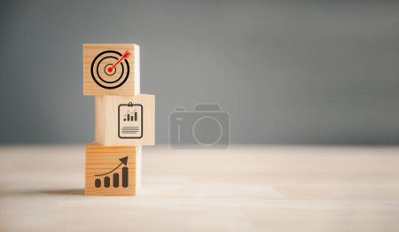 Photo for Cube wood blocks with Target icon on top, accompanied by rise up arrows. steps represent the vertical style of business growth process, emphasizing profit, investment, economic improvement concepts - Royalty Free Image