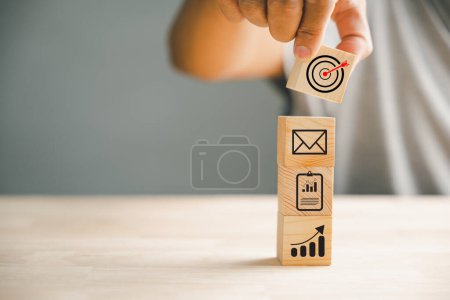 Photo for Wood block stacking skillfully arranged by a hand, representing a business strategy and Action plan. It signifies business development, growth, and success in the corporate world. - Royalty Free Image
