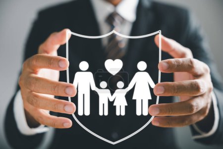 Insurance concept brought to life, Businessman with protective gesture ensures family security, incorporating life, health, and house coverage. Icons emphasize family life insurance and policy concept