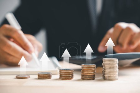Photo for An up arrow on graph underlines the rising real estate market. A house model and coin stack illustrate inflation, economic growth, and insurance service costs. The value of the property climbs higher. - Royalty Free Image