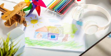 Photo for Child colorful drawing landscape my home dream on white paper, kid preschooler draw country house picture with pencil on table, arts homework concept - Royalty Free Image