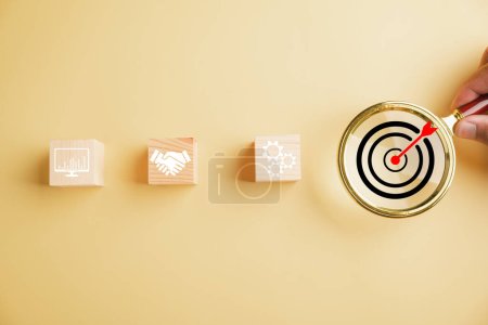 Photo for Magnifying glass zooms in on target icon, symbolizing intersection of start-up, creative ideas, and innovation. It signifies motivation, planning, development, and leadership for customer targeting. - Royalty Free Image