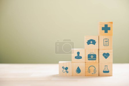 Photo for Pyramid of wooden cubes signifies healthcare and insurance commitment. Top medical insurance icon represents safety. Blue background accommodates copyspace for Health Insurance idea. - Royalty Free Image