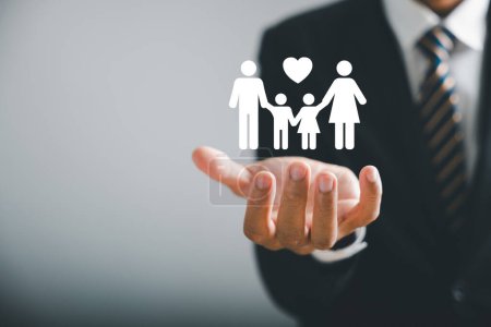 Photo for Family centered care, Businessman protective gesture complements young family silhouette. Health and house insurance icon symbolize protection, supporting family support concept. Family life insurance - Royalty Free Image