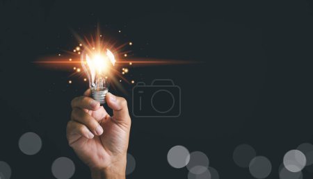 Photo for Innovation, brainstorming, and inspiration concepts are illustrated through a man holding a light bulb. This creative idea represents the fusion of innovative technology and business success. - Royalty Free Image