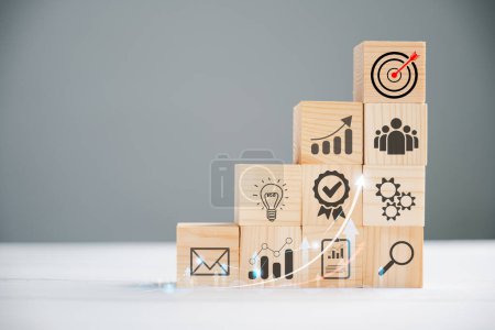 Photo for Business target concept with a wooden cube block step. Action Plan and Goal icons symbolize success. Project management and company strategy on a table. Teamwork background. - Royalty Free Image