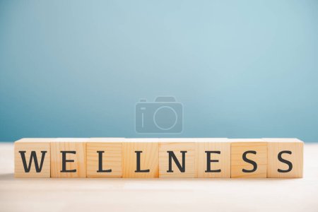 Photo for Wellness is highlighted by the word wellness on a wooden cube block, representing mental health, relaxation, and overall well-being. Encourages a healthy, stress-free lifestyle. wellness concept - Royalty Free Image