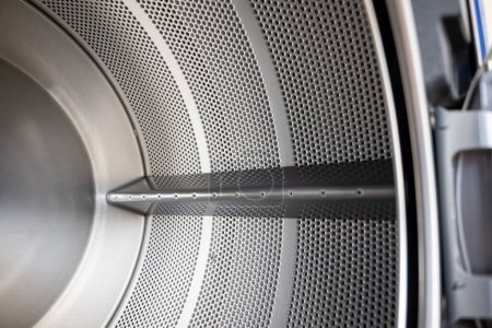 Photo for Close up Inside of washing machine tub with opened door is made of stainless steel, brand new drum material metal electrical household appliance, Empty inside - Royalty Free Image