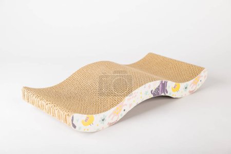 Photo for White background illuminates modern abstract cat scratching post dual-purpose piece with corrugated cardboard design. cat playful paw and alertness are what make this feline furniture a must-have. - Royalty Free Image